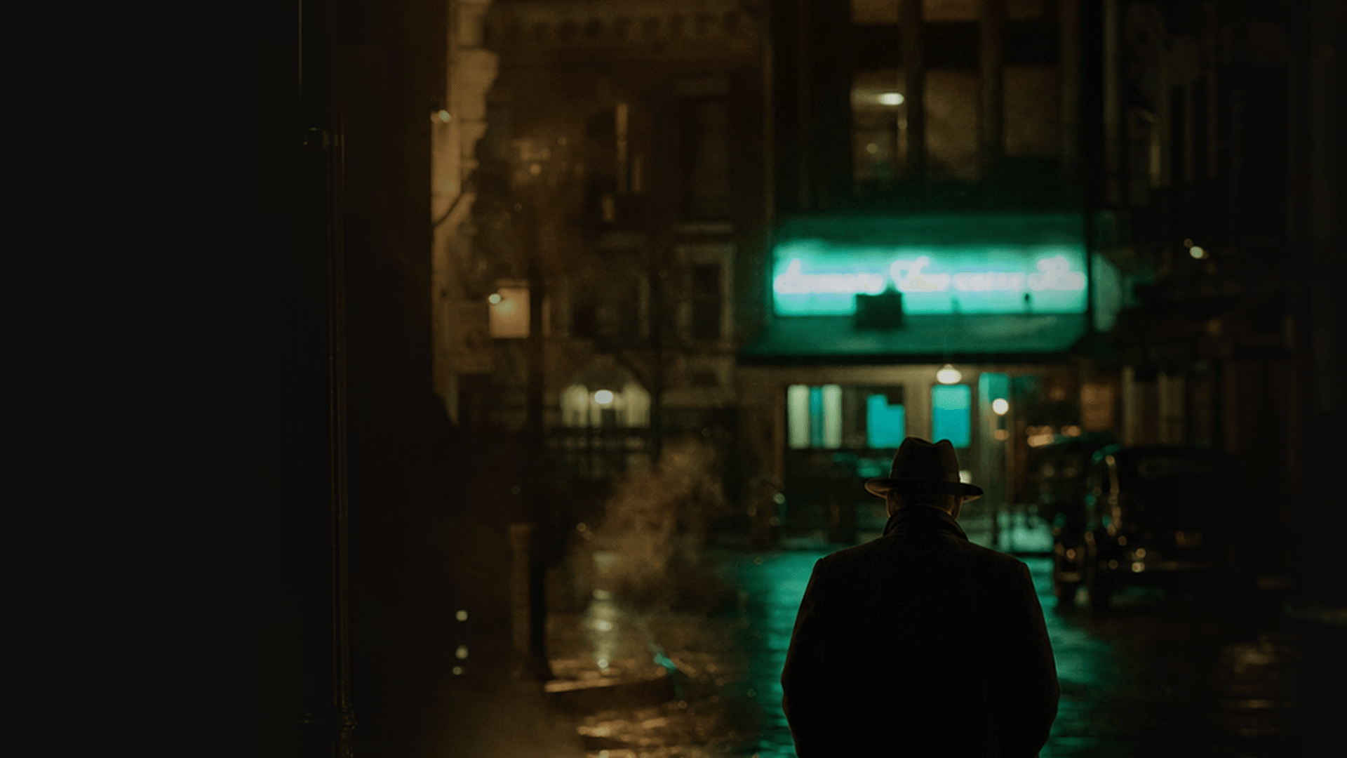 A figure in a hat seen from behind on a rain-slicked Chicago street; the Green Mill neon sign glows green in the distance